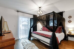 Master Bedroom with patio door,  King size canopy bed and 43" TV. 