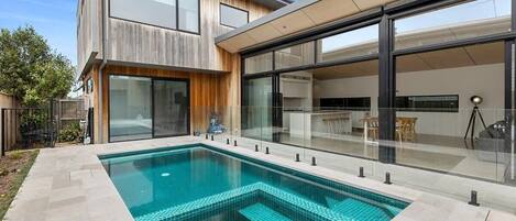 Step outside to the north-facing outdoor area, where the sparkling pool awaits
