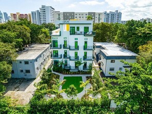 Four story building with rooftop deck, outdoor terrace and backyard garden