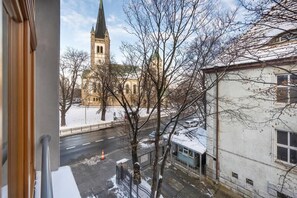 A wintery street view with a church in the background.