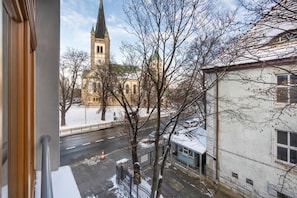 A wintery street view with a church in the background.