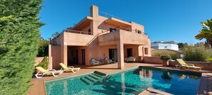 Villa - View from back side, with swimming pool and outside amenities.