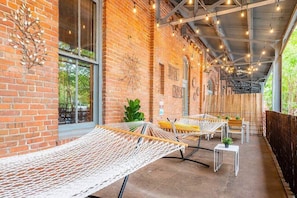 Private Balcony with 2 hammocks, table, & string lights