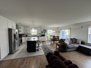 Open concept living room, kitchen and dining room.