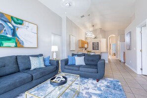 Living room with plush sofa and beautiful hanging frames