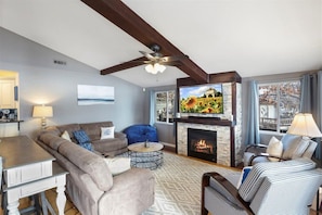 Main floor living room with 4 recliners and a gas fireplace for chilly days.