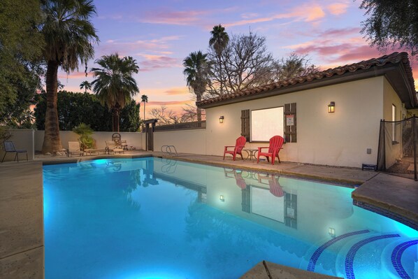 Spacious Pool with outdoor furniture seating area and fire pit