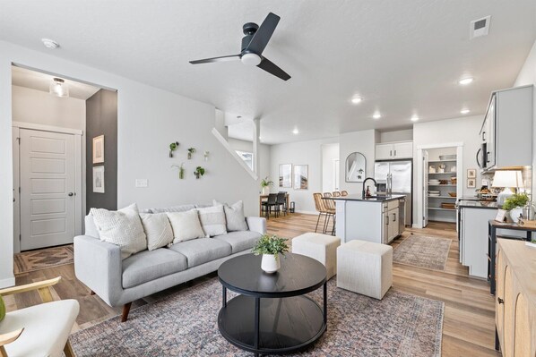 Relax in our inviting living room, seamlessly blending with the open kitchen. Ideal for gatherings, enjoy the cozy ambiance and shared moments in this comfortable space. Your perfect home away from home. 