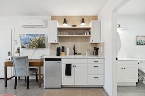 The kitchenette is fully stocked with silverware, utensils, a 2-burner cooker, coffee maker, toaster and all the basics you need to cook meals.