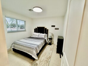 Queen size bed with fresh linens. 