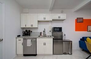 Newly remodeled with classic white shaker cabinets and beautiful quartz countertops, this kitchen is fully equipped with your kitchen essentials and appliances.