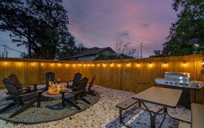 Toss some burgers and steaks onto the grill for an easy outdoor meal. After your meal, grab one of the loungers around the firepit and chat late into the night.