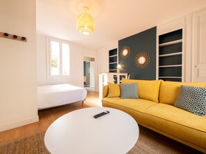 "Overall view of a studio with sitting area, bedroom area"