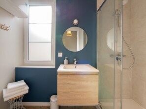 "Duck blue and white bathroom with spacious shower"