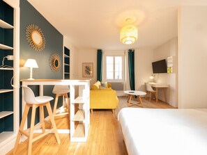 "Overview of a studio with dining and living area"