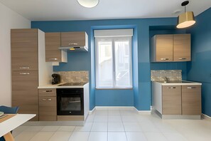 "Camélia's modern, fully-equipped kitchen".