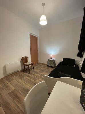 "Comfortable room with single bed and warm atmosphere"