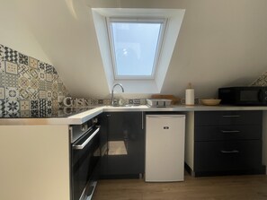 Fully equipped modern kitchen open to the living room.