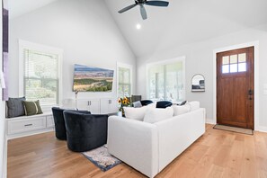 The living room is directly adjacent to the front door and kitchen area.