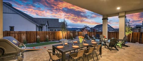 Covered Outdoor Living at its finest. Fire up the Stainless Steel Gas Grill and dine Al Fresco at the outdoor dining table seating 8. The perfect spot for catching up with Loved Ones