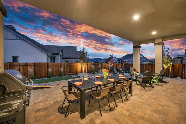 Covered Outdoor Living at its finest. Fire up the Stainless Steel Gas Grill and dine Al Fresco at the outdoor dining table seating 8. The perfect spot for catching up with Loved Ones