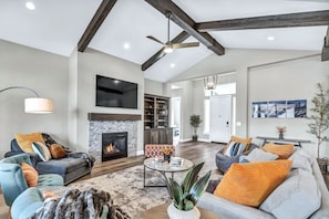 Enjoy comfort & casual sophistication in the spacious Great Room w/ high vaulted ceilings, cozy gas fireplace and 70" smart TV