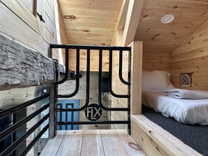Sleeping loft has 2 twin floor mattresses.
