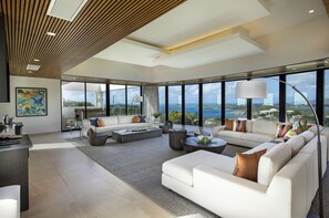 Living room with views of jacuzzi deck, the front of the property and ocean view