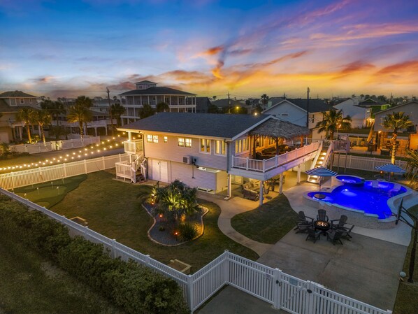 Relax by the sparkling pool on a vibrant patio under twinkling lights!