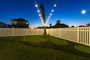 Challenge friends under twinkling lights in your private putting green!