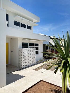 Facade - come down the main front steps, across breeze blocks to the Green Door