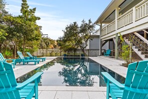 Relax in the private pool surrounded by lush greenery.