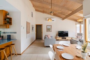 Gather around the dining table with a view of the inviting lounge – where shared meals and cosy moments come together effortlessly.