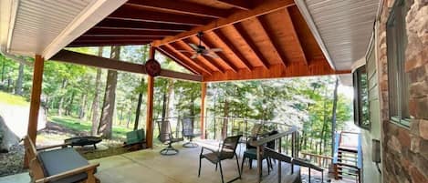 Embrace the great outdoors from our spacious deck, featuring transparent cable railings that offer clear views of the natural stone landscaping and wooded scenery.