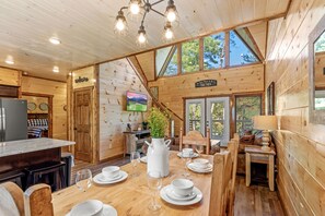 Entrance view of the dining table, living with vaulted ceiling
