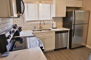 Updated kitchen with new cabinets and countertops and stainless appliances