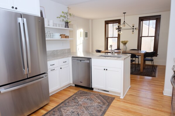 beautiful open kitchen w/ new ss appliances, open shelving, appliance cabinet