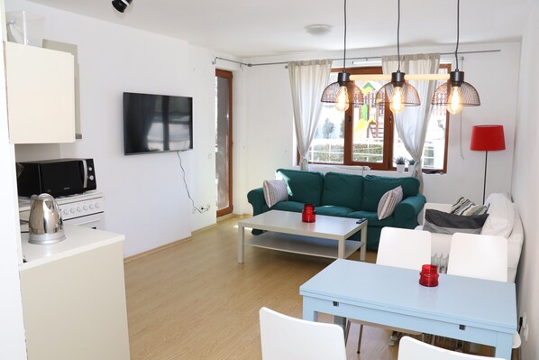 Cozy Living Room  With a TV, Dining Table for 4 Persons