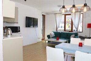 Cozy Living Room  With a TV, Dining Table for 4 Persons