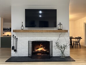 Wood Burning Fireplace + 65" TV