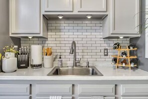 The fully equipped kitchen has everything you need to whip up a delicious meal, including a stove, oven, microwave, and refrigerator. A dining area is also available for enjoying your home-cooked creations.