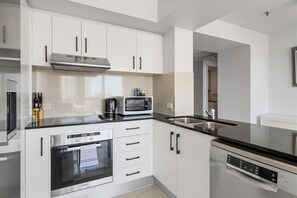 Savor the joy of cooking in a fully equipped kitchen, complete with essentials like oil and a coffee maker