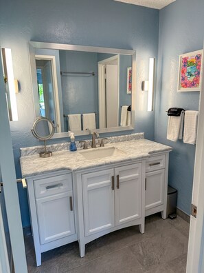 Marble counter vanity and plenty of room for storing your toiletries