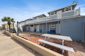 Witness a unique standpoint from the exterior, showcasing a porch and conveniently placed across from the mesmerizing Galveston Seawall