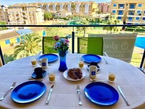 Wake up each morning with the warm Mediterranean sun on our charming terrace. Enjoy a delicious breakfast overlooking the tranquil urbanization and its pool.