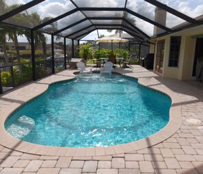 Screened in lanai and pool facing south