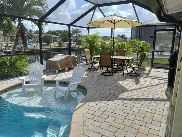 Screened in lanai and pool with sun shelf