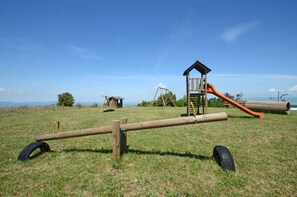 The playground is behind the swimming pool