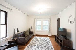 The living room is a comfortable and inviting space, perfect for relaxation and unwinding. With cozy seating and stylish decor, it sets the stage for memorable moments and quality time. Whether you're watching your favorite show or reading a book.