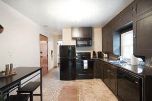 The kitchen is a functional and well-equipped space, ready to inspire your culinary adventures. With modern appliances, ample counter space, and all the necessary cooking essentials, it provides everything you need to prepare delicious meals.